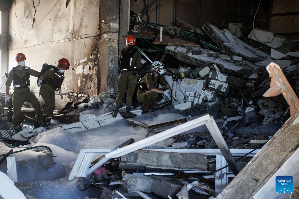 Israeli security forces work at a factory damaged in a rocket attack from Lebanon, at Na'aman industrial park in Acre, northern Israel, on Oct. 23, 2024. A barrage of 25 projectiles was fired from Lebanon into the Western Galilee region, most of which were intercepted by the Israeli air defense, according to the Israel Defense Forces (IDF). (Photo: Xinhua)