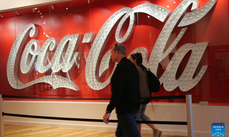 Visitors walk past a Coca-Cola logo at the World of Coca-Cola in Atlanta, Georgia, the United States, on Oct. 23, 2024. Coca-Cola shares fell nearly 2 percent on Wednesday after the company reported weaker-than-expected third-quarter unit case volumes. (Photo: Xinhua)