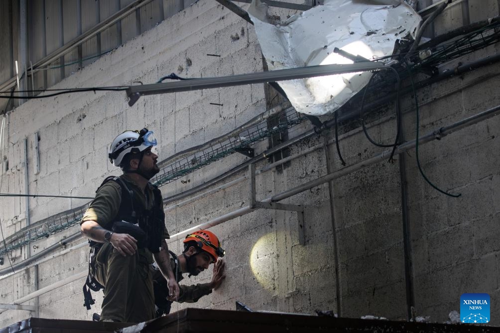 Israeli security forces work at a factory damaged in a rocket attack from Lebanon, at Na'aman industrial park in Acre, northern Israel, on Oct. 23, 2024. A barrage of 25 projectiles was fired from Lebanon into the Western Galilee region, most of which were intercepted by the Israeli air defense, according to the Israel Defense Forces (IDF). (Photo: Xinhua)