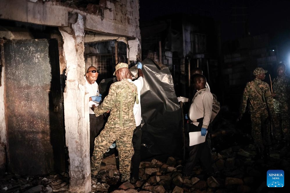 Investigators check the site of a fuel tanker blast in central district of Wakiso, Uganda, Oct. 22, 2024. At least 11 people died and several others were injured after a tanker truck carrying fuel burst into flames in the central Ugandan district of Wakiso, police said in an update. (Photo: Xinhua)