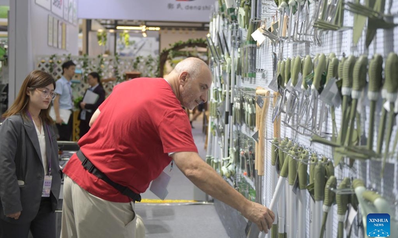 A buyer selects goods at the 136th China Import and Export Fair in Guangzhou, south China's Guangdong Province, Oct. 23, 2024. The second phase of the 136th China Import and Export Fair, popularly known as the Canton Fair, opened in Guangzhou on Wednesday focusing on displaying products such as household goods, gifts, decorations, building materials and furniture. (Photo: Xinhua)