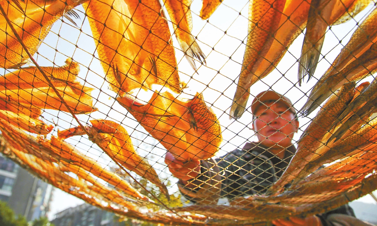 A fisherman dries fishes in Lianyungang, East China's Jiangsu Province on October 24, 2024. Fishermen are transforming them into traditional dried fish for the market. Photo: IC