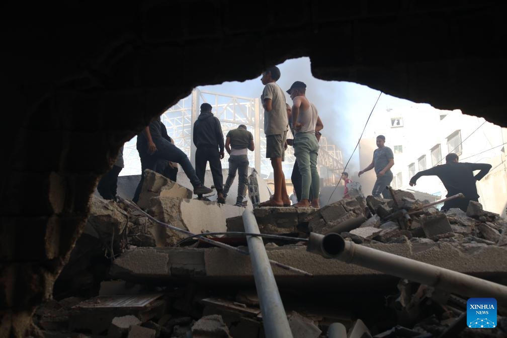 People gather at a destroyed building after an Israeli airstrike in the Al-Maghazi refugee camp, central Gaza Strip, on Oct. 24, 2024. The Palestinian death toll from ongoing Israeli attacks in the Gaza Strip has risen to 42,847, Gaza-based health authorities said in a statement on Thursday (Photo: Xinhua)