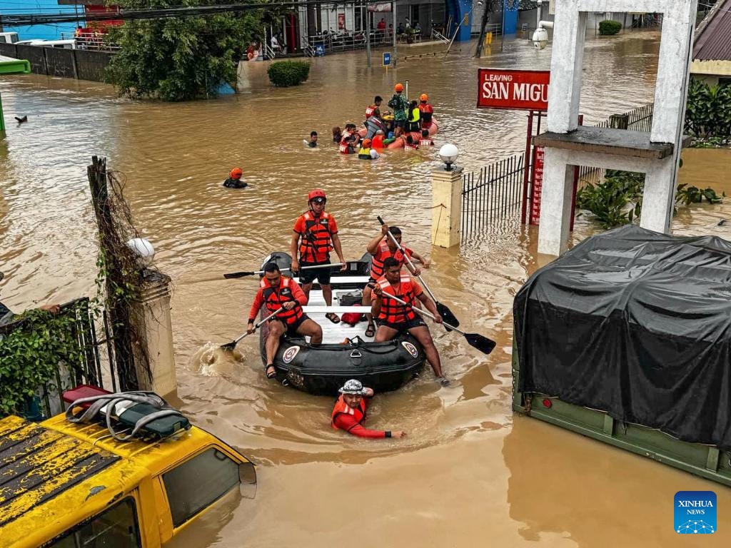 Rescuers evacuate residents from the floods caused by Tropical Storm Trami in Camarines Sur Province, the Philippines on Oct. 24, 2024. At least 22 people have been killed and nine others are missing due to massive flooding and landslides triggered by Tropical Storm Trami, which continues to rip through the Philippines on Thursday, authorities said. (Photo: Xinhua)