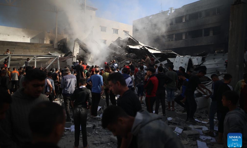 People gather at a destroyed building after an Israeli airstrike in the Al-Maghazi refugee camp, central Gaza Strip, on Oct. 24, 2024. The Palestinian death toll from ongoing Israeli attacks in the Gaza Strip has risen to 42,847, Gaza-based health authorities said in a statement on Thursday (Photo: Xinhua)