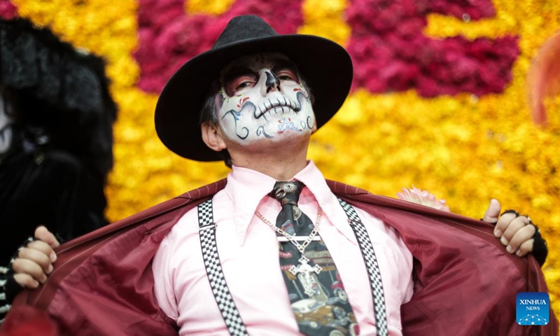 A citizen with facial makeup participates in the media presentation of the Day of the Dead activities in Mexico City, Mexico, on Oct. 21, 2024. Day of the Dead is a Mexican holiday involving family and friends gathering to pray for and remember friends and family members who have died. (Photo: Xinhua)