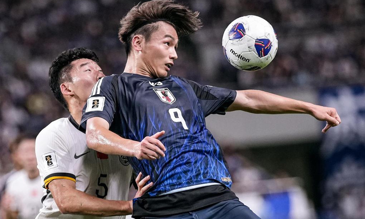 Zhu Chenjie (left) of China vies with Ueda Ayase of Japan during their 2026 FIFA World Cup Asian qualifier in Saitama, Japan, on September 5, 2024. China suffered a 7-0 defeat to Japan in the 2026 FIFA World Cup Asian qualifiers. Photo: Xinhua