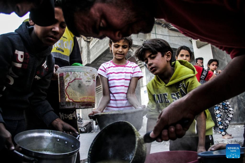 Palestinians receive food relief in Gaza City, Oct. 23, 2024. About 1.84 million people across the Gaza Strip are experiencing high levels of acute food insecurity, including nearly 133,000 people facing catastrophic food insecurity, according to a recent report released by the World Food Programme and the Food and Agriculture Organization. (Photo: Xinhua)