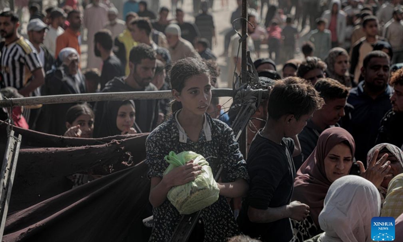 Palestinians wait to buy bread from the only operating bakery in the southern Gaza Strip city of Khan Younis, Oct. 23, 2024. About 1.84 million people across the Gaza Strip are experiencing high levels of acute food insecurity, including nearly 133,000 people facing catastrophic food insecurity, according to a recent report released by the World Food Programme and the Food and Agriculture Organization. (Photo: Xinhua)