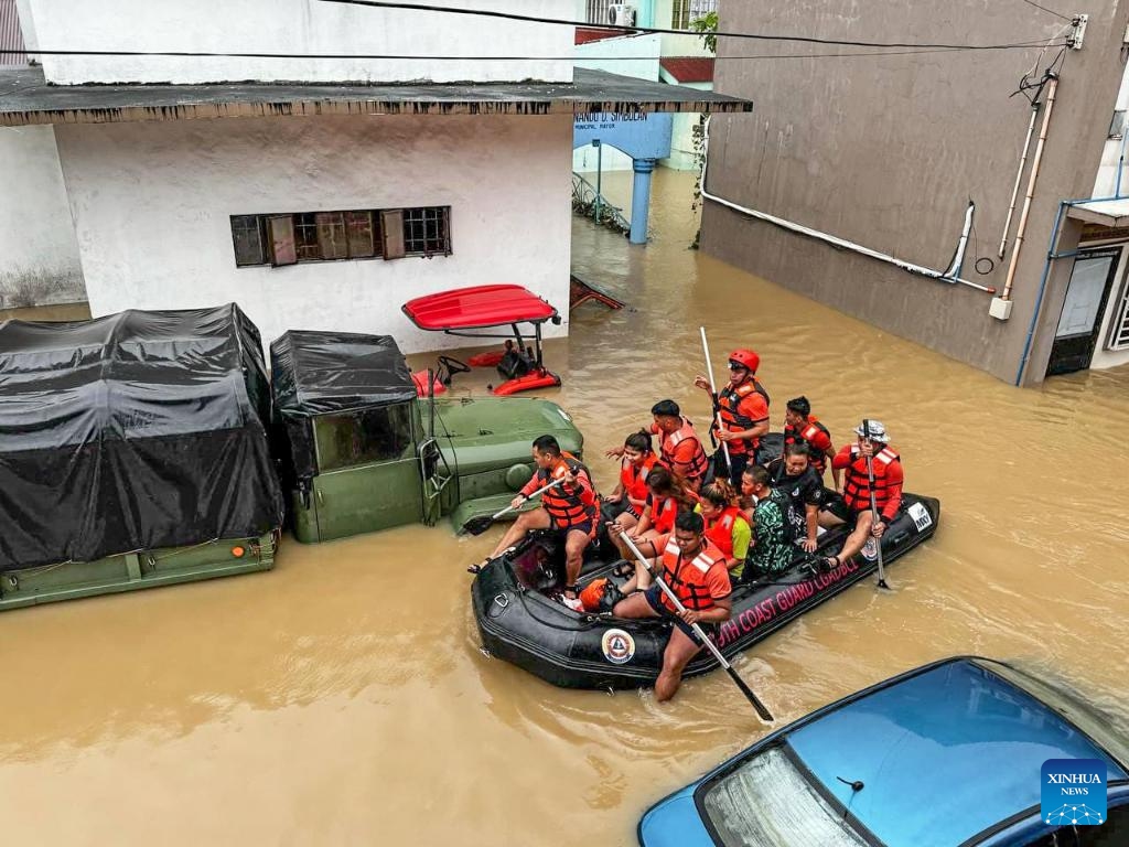 Rescuers evacuate residents from the floods caused by Tropical Storm Trami in Camarines Sur Province, the Philippines on Oct. 24, 2024. At least 22 people have been killed and nine others are missing due to massive flooding and landslides triggered by Tropical Storm Trami, which continues to rip through the Philippines on Thursday, authorities said. (Photo: Xinhua)