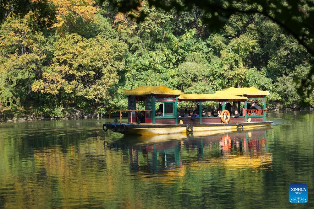 Tourists enjoy the autumn scenery on a sight-seeing boat at the Summer Palace in Beijing, capital of China, on Oct. 24, 2024. The Summer Palace is China's largest imperial park and among the most noted classical gardens in the world. In 1998, it was listed as one of the World Heritage Sites by UNESCO. (Photo: Xinhua)