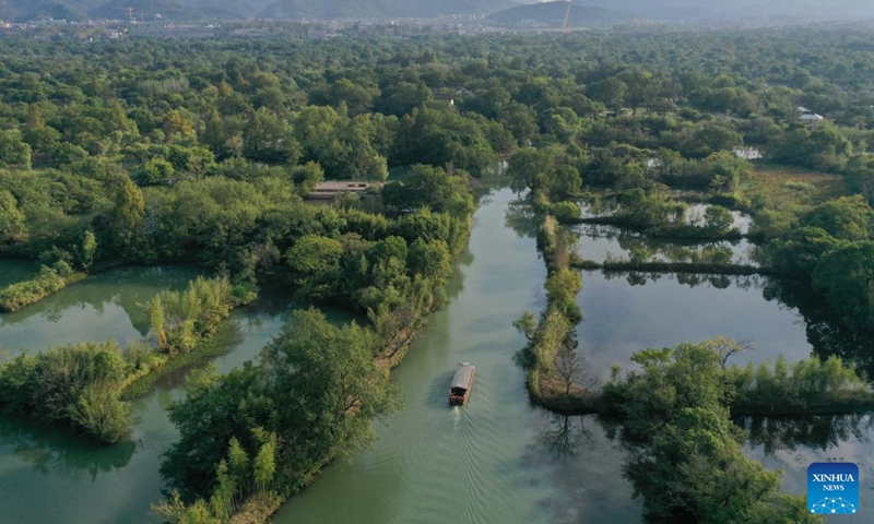 An aerial drone photo shows a sightseeing boat at the Xixi National Wetland Park in Hangzhou, east China's Zhejiang Province, Oct. 24, 2024. The wetland park attracts many tourists with its beautiful autumn scenery. (Photo: Xinhua)