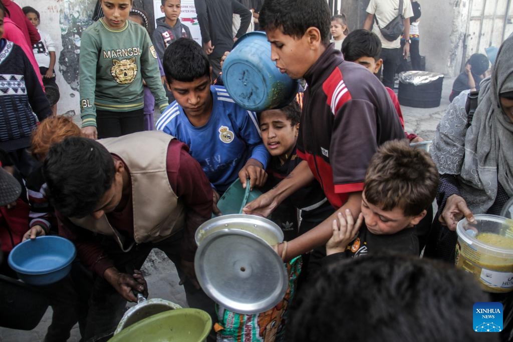 Palestinians receive food relief in Gaza City, Oct. 23, 2024. About 1.84 million people across the Gaza Strip are experiencing high levels of acute food insecurity, including nearly 133,000 people facing catastrophic food insecurity, according to a recent report released by the World Food Programme and the Food and Agriculture Organization. (Photo: Xinhua)