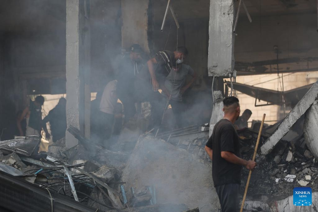 People search among the rubble of a destroyed building after an Israeli airstrike in the Al-Maghazi refugee camp, central Gaza Strip, on Oct. 24, 2024. The Palestinian death toll from ongoing Israeli attacks in the Gaza Strip has risen to 42,847, Gaza-based health authorities said in a statement on Thursday. (Photo: Xinhua)