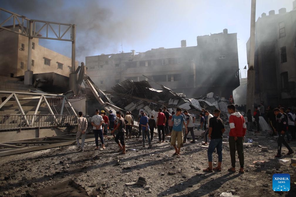 People gather at a destroyed building after an Israeli airstrike in the Al-Maghazi refugee camp, central Gaza Strip, on Oct. 24, 2024. The Palestinian death toll from ongoing Israeli attacks in the Gaza Strip has risen to 42,847, Gaza-based health authorities said in a statement on Thursday (Photo: Xinhua)