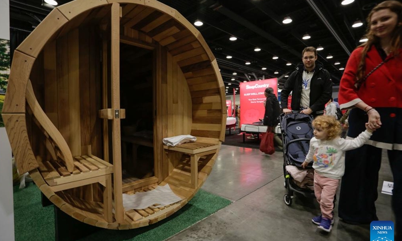 Visitors view a sauna capsule during Vancouver Fall Home Show 2024 at the Vancouver Convention Centre in Vancouver, British Columbia, Canada, Oct. 24, 2024. The four-day event kicked off on Thursday, featuring over 300 exhibitors showcasing their latest products and services. (Photo: Xinhua)