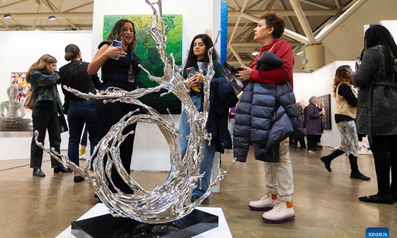 Visitors look at an artwork during the Art Toronto 2024 in Toronto, Canada, on Oct. 25, 2024. (Photo: Xinhua)