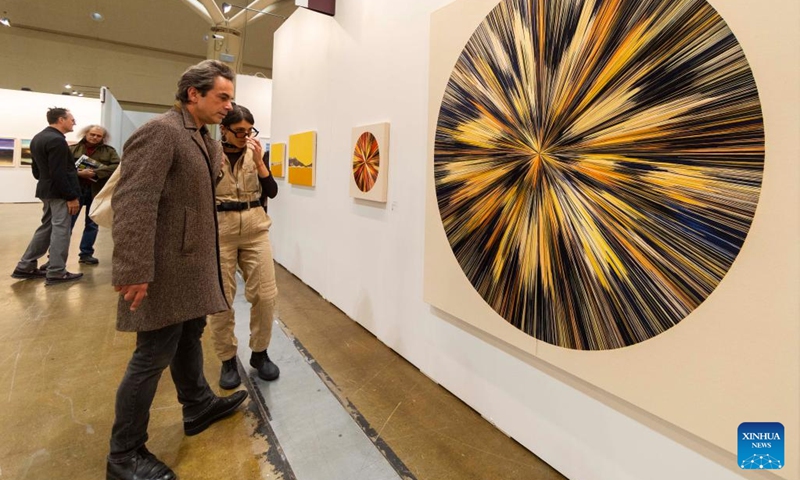 Visitors look at an artwork during the Art Toronto 2024 in Toronto, Canada, on Oct. 25, 2024. (Photo: Xinhua)