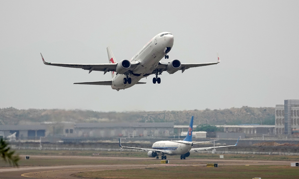 A passenger plane flies over the Jinwan Airport in Zhuhai, South China's Guangdong Province on October 27, 2024. Airlines begin to execute winter and spring flight plans, with 194 domestic and foreign airlines planning to operate 118,000 flights per week, up 1.2 percent from the previous year, according to the Civil Aviation Administration of China. Photo: VCG