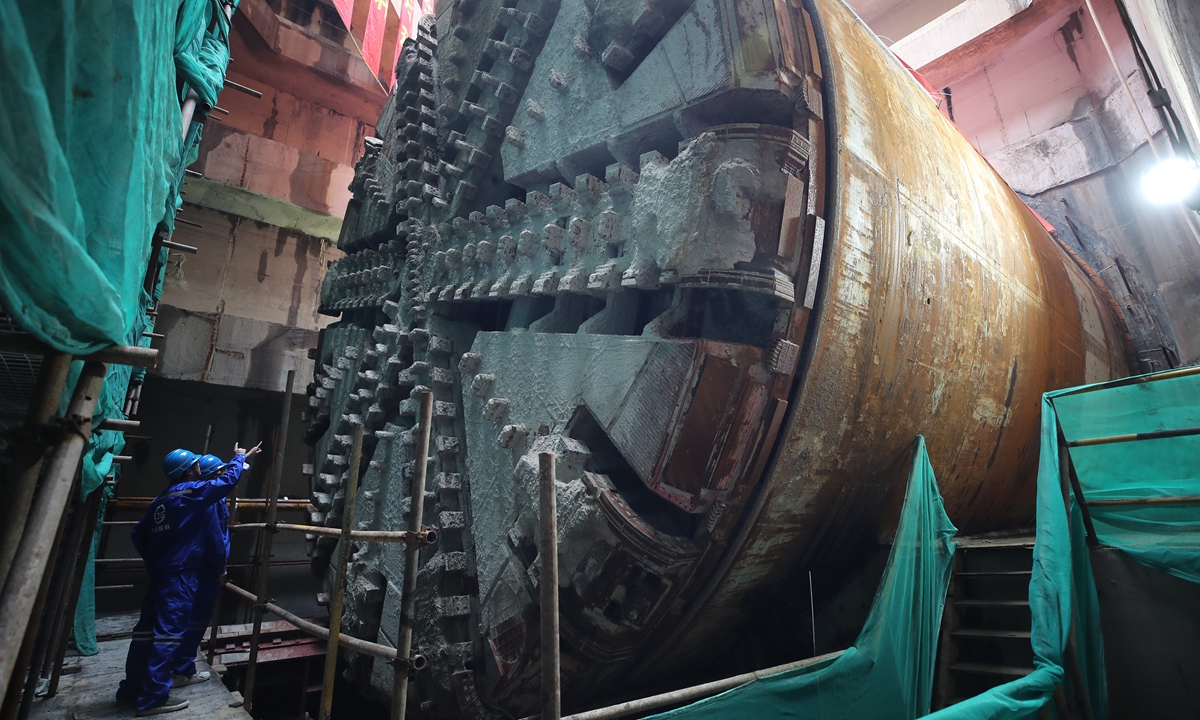 Engineers inspect a tunnel boring machine as it completes its mission after digging a length of 6.77 kilometers under the Yangtze River over 817 days in Shanghai on October 28, 2024. The underwater tunnel will connect Shanghai's Pudong district to the national railway network. Photo: VCG