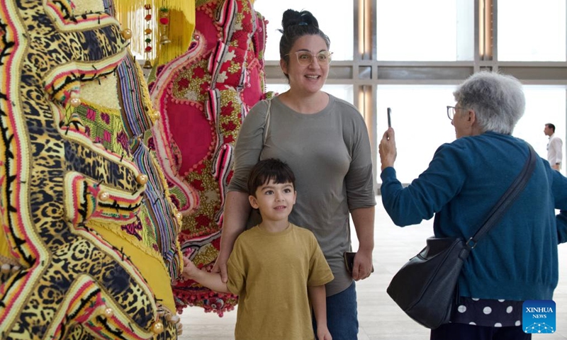 People pose for a photo with an artwork at the Malta International Contemporary Arts Space in Floriana, Malta, on Oct. 27, 2024. The Malta International Contemporary Arts Space, Malta's first ever national contemporary arts museum, officially opened to the public on Sunday. (Photo: Xinhua)