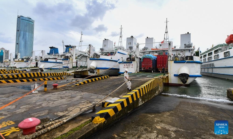 A boatman works at Xiuying Port before departure in Haikou, south China's Hainan Province, Oct. 27, 2024. The Xinhai Port, Xiuying Port and a railway port in Haikou resumed operation on Sunday afternoon as the impact of Typhoon Trami, this year's 20th typhoon, weakened. (Photo: Xinhua)