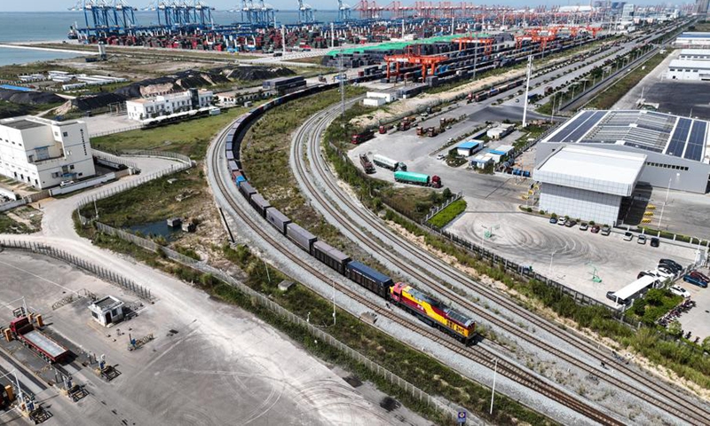 An aerial drone photo taken on Oct. 24, 2024 shows a train leaving Qinzhou Port in Qinzhou, south China's Guangxi Zhuang Autonomous Region. (Photo: Xinhua)