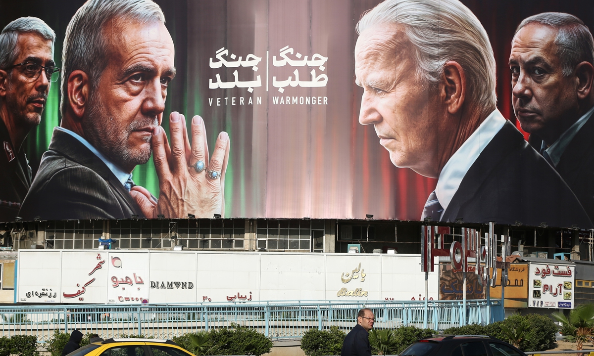 The huge banner with photos of Iranian President Masoud Pezeshkian (second left), Chairman of the Chiefs of Staff of the Iranian Armed Forces Mohammad Baqeri (first left), US President Joe Biden (second right), and Israeli Prime Minister Benjamin Netanyahu (first right) hung in the Iranian capital on October 28, 2024, following the Israeli missile attack on Iran. Photo: VCG