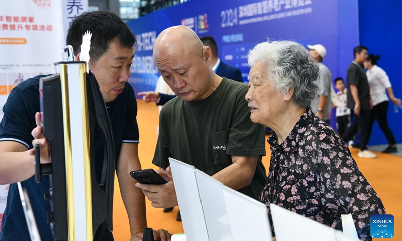 Senior citizens learn about a smart door lock at the 2024 Shenzhen International Intelligent Elderly Care Industry Expo in Shenzhen, south China's Guangdong Province, Oct. 27, 2024. A total of 203 exhibitors from home and abroad have brought more than 1,000 products and technologies for elderly care to the expo, which was held from Oct. 25 to 27 in Shenzhen. (Photo: Xinhua)