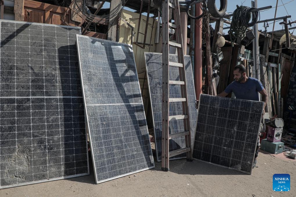 A Palestinian engineer works to repair solar panels in the Mawasi area of Khan Younis in the southern Gaza Strip, on Oct. 27, 2024. Displaced people here are amid ongoing energy crisis and power outages, which have lasted for more than a year due to the Israeli aggression on the Gaza Strip. (Photo: Xinhua)