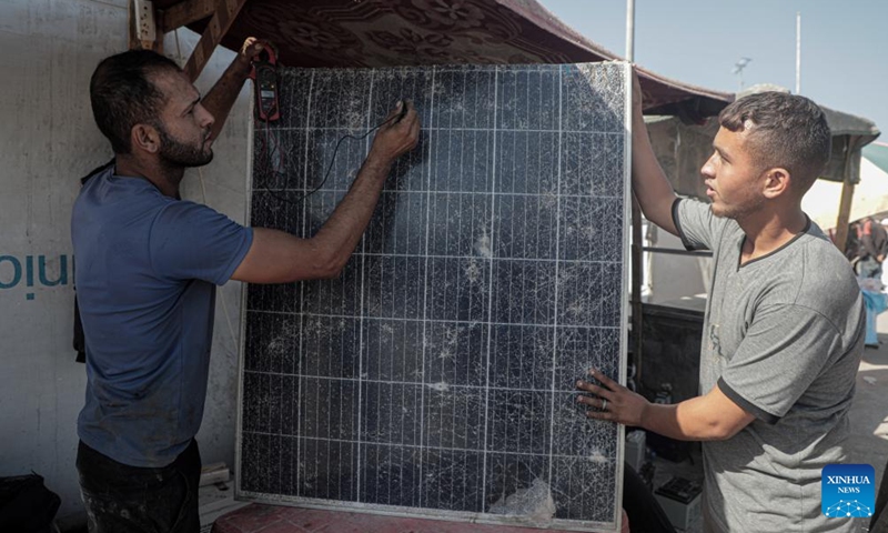 Palestinian engineers work to repair solar panels in the Mawasi area of Khan Younis in the southern Gaza Strip, on Oct. 27, 2024. Displaced people here are amid ongoing energy crisis and power outages, which have lasted for more than a year due to the Israeli aggression on the Gaza Strip. (Photo: Xinhua)