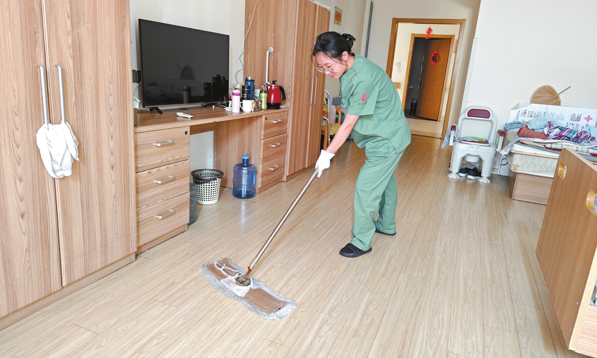 Jiang Hao does cleaning at an eldercare home she works for in East China's Shandong Province. Photo: Courtesy of Jiang