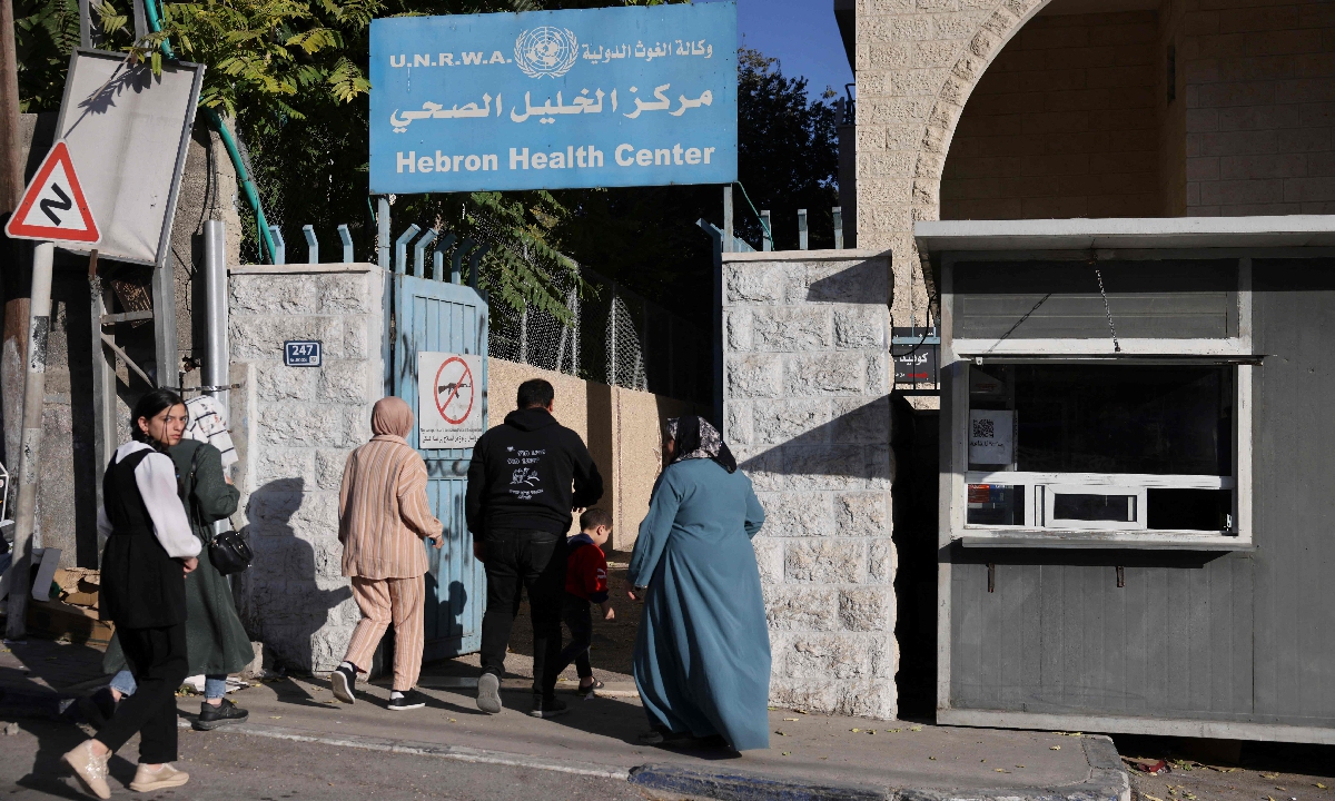 Palestinians enter the UNRWA (United Nations Relief and Works Agency) health centre, which provides free treatment, in the occupied West Bank city of Hebron on October 29, 2024. Photo: VCG