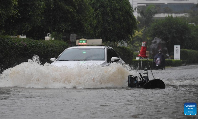 A taxi moves through a waterlogged road in Sanya, south China's Hainan Province, Oct. 28, 2024. Some parts of Hainan Province experienced heavy rainfall due to the influence of Typhoon Trami. (Photo: Xinhua)