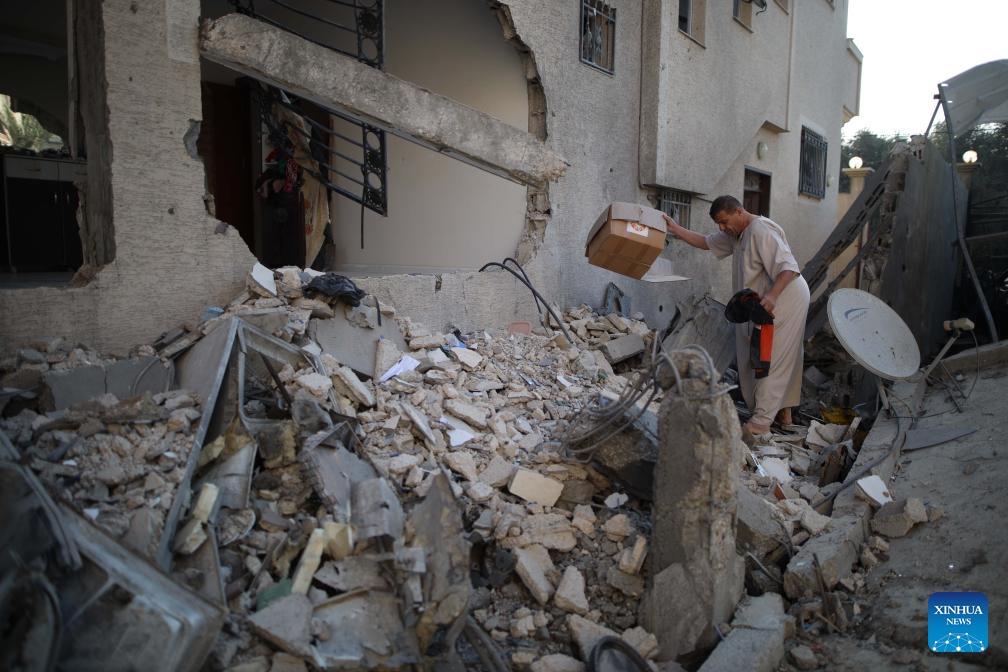 A man collects items from the rubble after an Israeli attack in al-Nuseirat refugee camp, central Gaza Strip, on Oct. 28, 2024. The Palestinian death toll from ongoing Israeli attacks on the Gaza Strip has surpassed 43,000, Gaza-based health authorities said in a statement on Monday. (Photo: Xinhua)