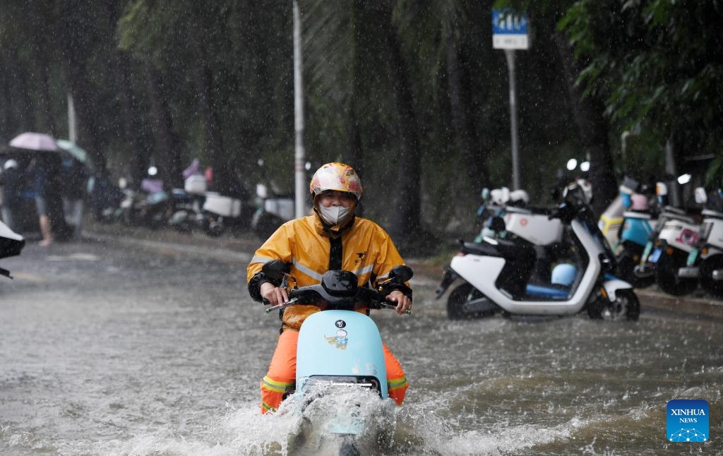 A man rides an electric scooter through a waterlogged road in Sanya, south China's Hainan Province, Oct. 28, 2024. Some parts of Hainan Province experienced heavy rainfall due to the influence of Typhoon Trami. (Photo: Xinhua)