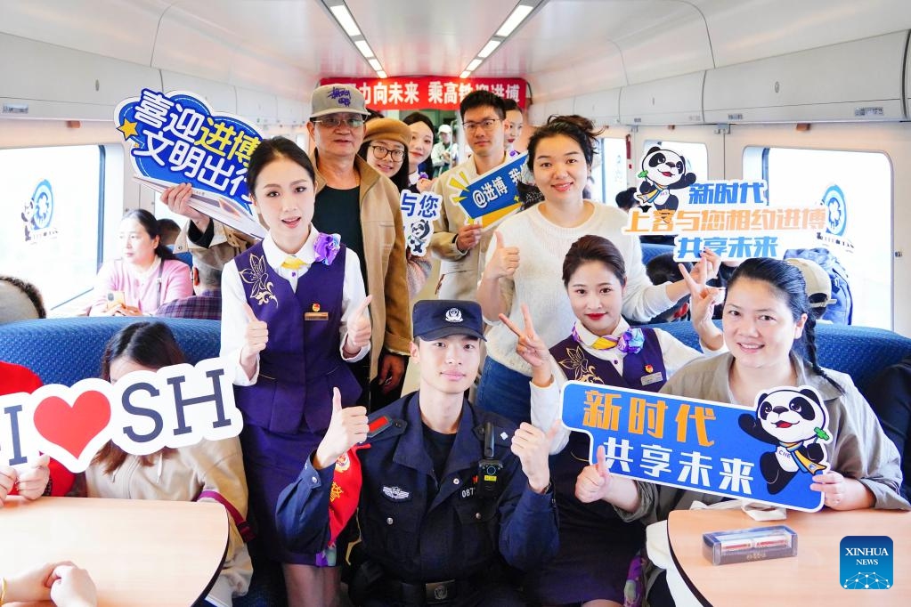 Passengers and crew members pose for a group photo during a promotion event for the seventh China International Import Expo (CIIE) on the train D3205 on Oct. 28, 2024. The CIIE is scheduled to take place in Shanghai from Nov. 5 to 10. (Photo: Xinhua)