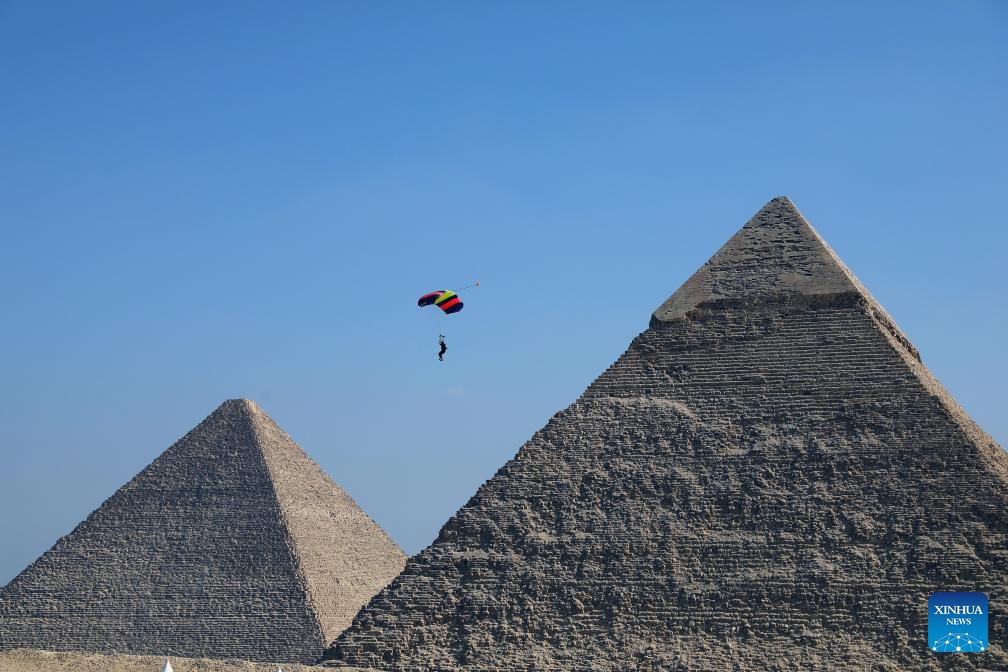 A skydiver flies by a pyramid during the skydiving festival Jump Like a Pharaoh at Giza Pyramids scenic spot in Giza, Egypt, on Oct. 29, 2024. The seventh edition of the skydiving festival kicked off at the Giza Pyramids on Tuesday, attracting around 200 skydivers. (Photo: Xinhua)