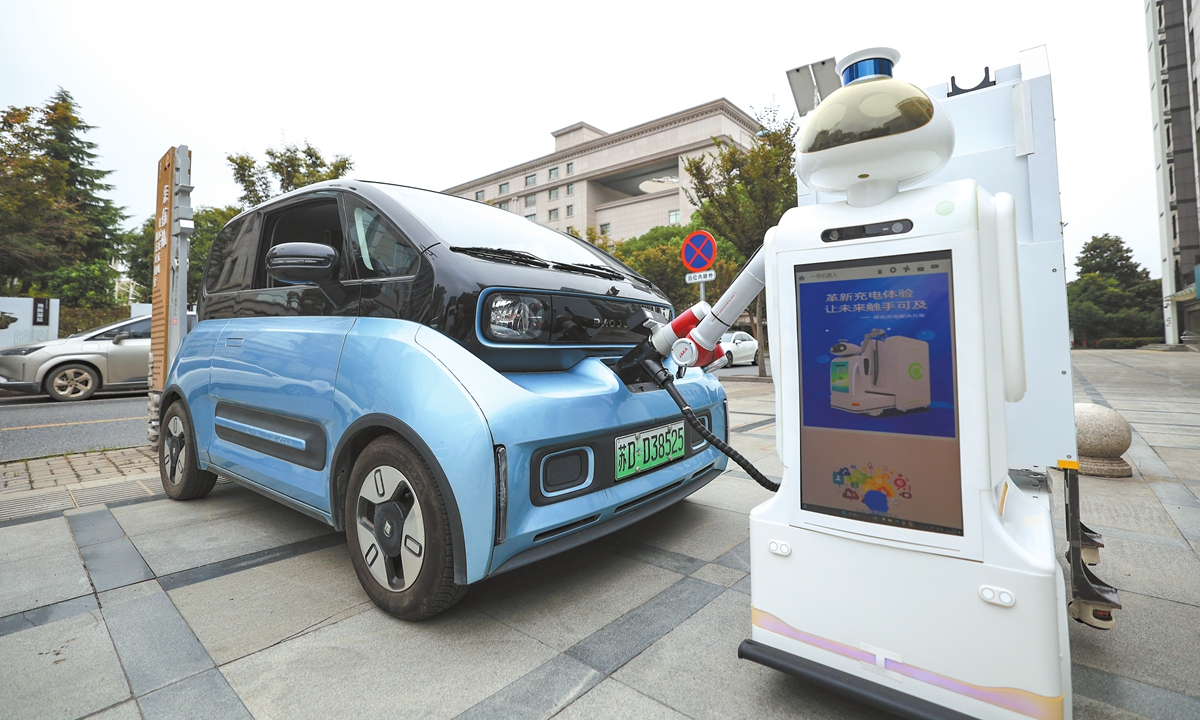 An intelligent charging robot charges a new energy vehicle (NEVs) at a smart charging service station in the Jindong district of Jinhua, East China's Zhejiang Province, on October 30, 2024. China's NEV ownership reaches 24.72 million by end of June, data showed. Photo: VCG