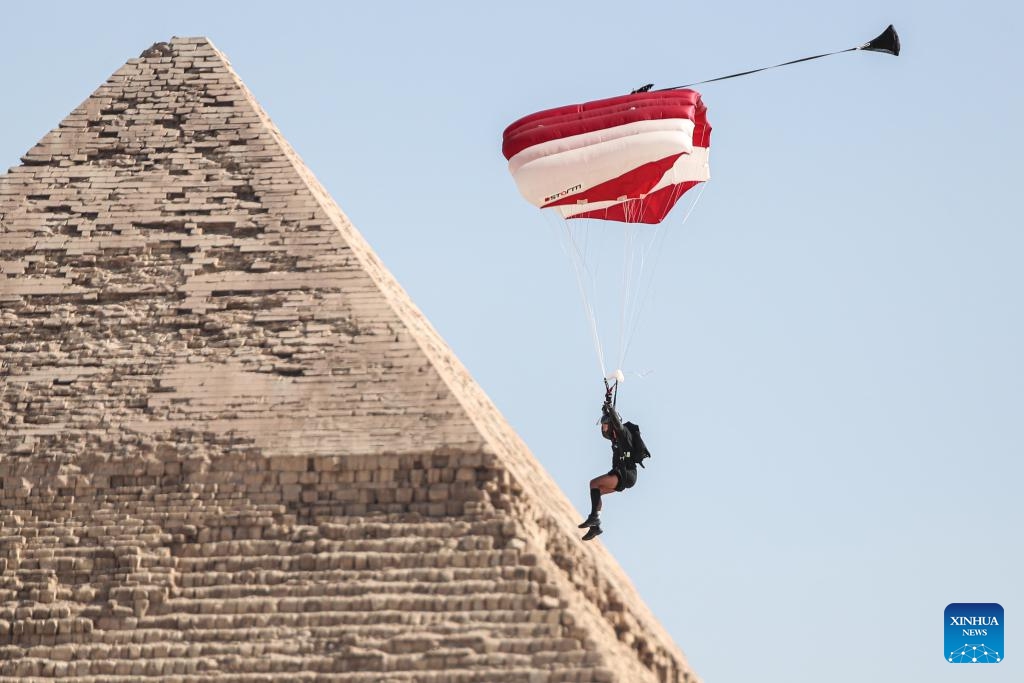 A skydiver flies by a pyramid during the skydiving festival Jump Like a Pharaoh at Giza Pyramids scenic spot in Giza, Egypt, on Oct. 29, 2024. The seventh edition of the skydiving festival kicked off at the Giza Pyramids on Tuesday, attracting around 200 skydivers. (Photo: Xinhua)