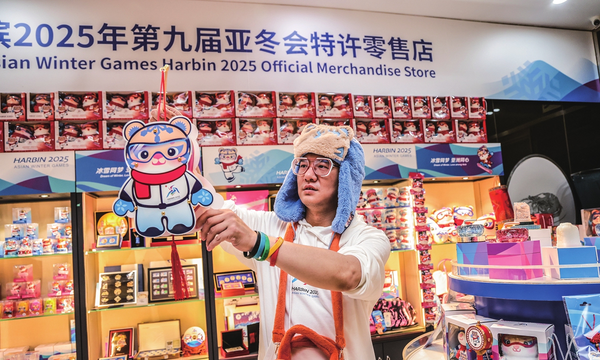 A visitor displays a licensed product for the 9th Asian Winter Games Harbin 2025 in Beijing on October 31, 2024. On the same day, the countdown to the 9th Asian Winter Games hit the 100-day mark. All new products with a 100-day countdown theme for commemorative sales have started pre-sales in official online flagship stores and authorized physical retail stores across the country. Photo: VCG