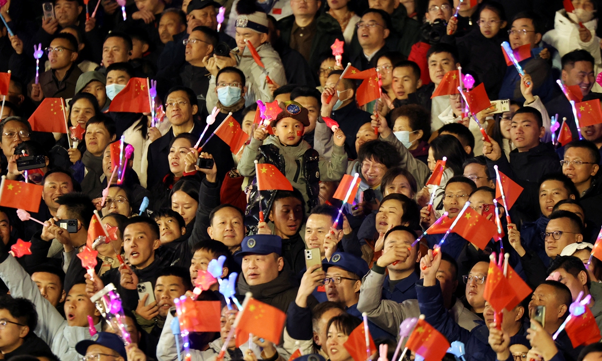 People wave Chinese national flags at the see-off ceremony at the Jiuquan Satellite Launch Center on October 30, 2024. Photo: IC