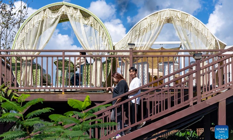 Tourists take a walk at the Qiao'an coffee plantation in the Dai-Lahu-Va Autonomous County of Menglian, Pu'er City of southwest China's Yunnan Province, Oct. 30, 2024. Pu'er City is the largest coffee-producing area in China. Through the layout of the whole industrial chain, coffee plantations play a significant role and inject new vitality into the high-quality development of local coffee industry. (Photo: Xinhua)