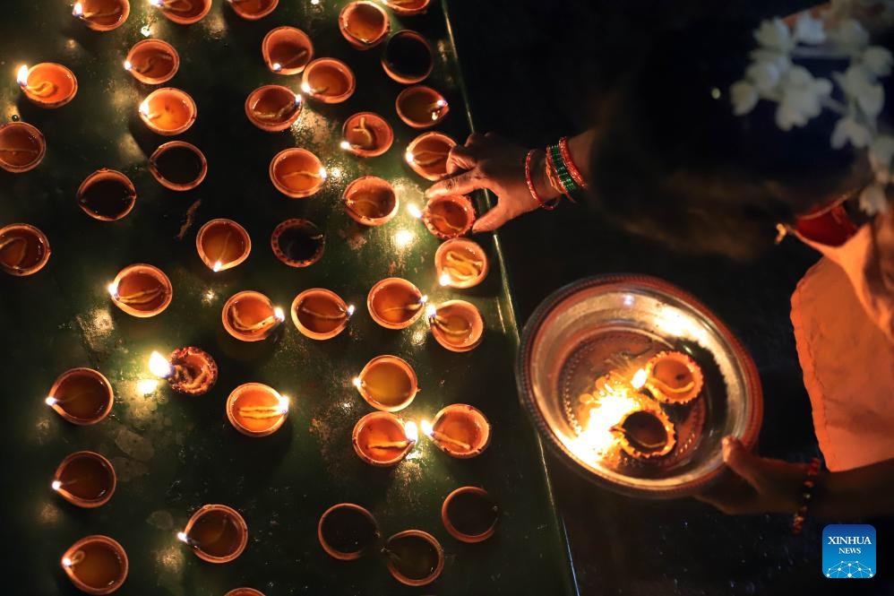 A Hindu devotee lights oil lamps to celebrate Diwali, the Hindu festival of lights, at a Hindu temple in Colombo, Sri Lanka on Oct. 31, 2024. (Photo: Xinhua)