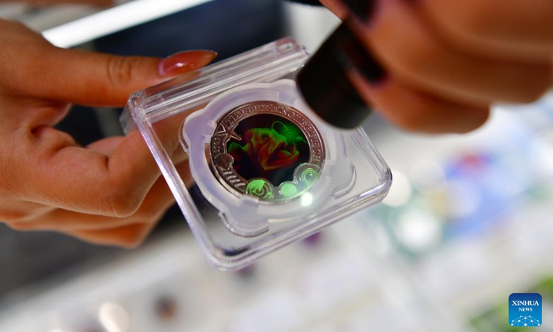 A fluorescent commemorative copper coin issued by Austria in 2023 is seen during the Beijing International Coin Exposition 2024 at the China National Convention Center in Beijing, capital of China, Nov. 1, 2024. (Photo: Xinhua)