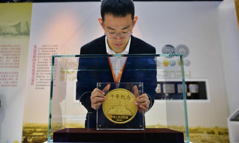 An exhibitor shows a commemorative gold coin weighing 10 kilograms during the Beijing International Coin Exposition 2024 at the China National Convention Center in Beijing, capital of China, Nov. 1, 2024. (Photo: Xinhua)