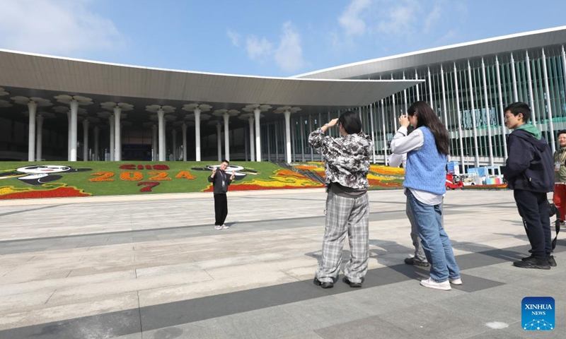 An exhibitor poses for photos at the south square of the National Exhibition and Convention Center (Shanghai), the main venue for the 7th China International Import Expo (CIIE), in east China's Shanghai, Nov. 2, 2024. Preparations for the 7th CIIE, which is scheduled to take place in Shanghai from Nov. 5 to 10, have entered the final stage.  (Photo: Xinhua)