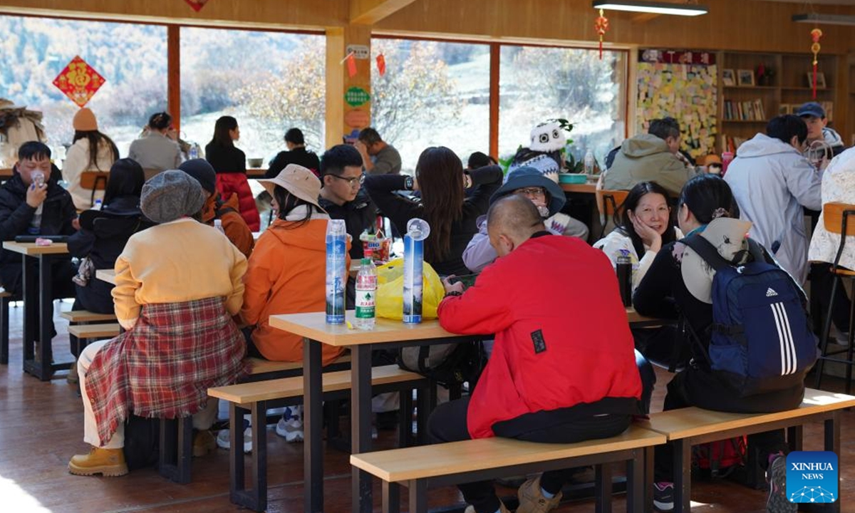 Tourists take a rest at a service station of Yading scenic spot in Daocheng County of Tibetan Autonomous Prefecture of Garze, southwest China's Sichuan Province, Oct. 31, 2024. (Photo: Xinhua)