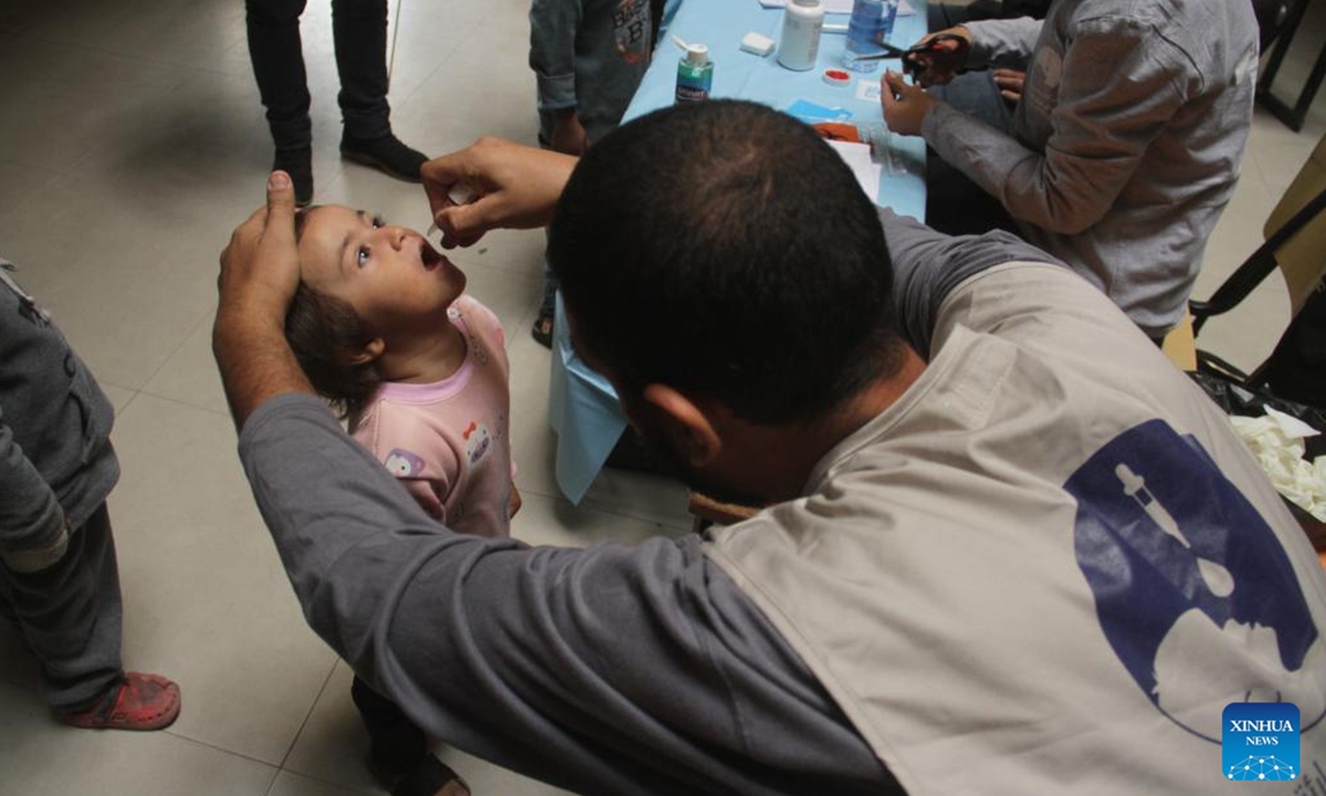 A Palestinian child receives a dose of polio vaccine at a UN-run school in Gaza City, on Nov. 2, 2024. A third phase of the polio vaccination campaign in the northern Gaza Strip is set to resume on Saturday after being postponed over escalating violence, a UN statement said on Friday. (Photo: Xinhua)