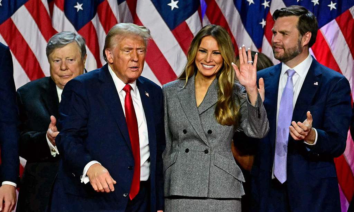 Republican presidential candidate Donald Trump gestures to audience with his family and running mate at his election night party on November 6, 2024. Photo: VCG